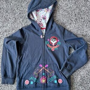 Pre worn grey kids’ Disney store Coco zip-up jacket- size: 9/10